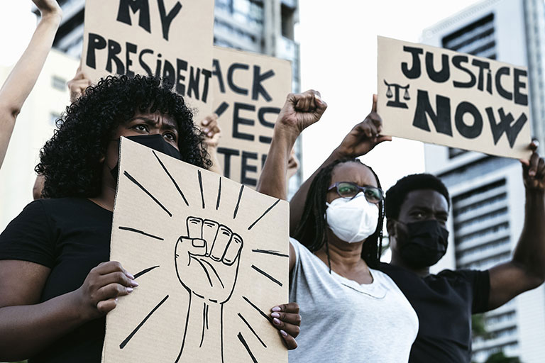 A group of protestors wearing COVID-19 masks at a Black Lives Matter gathering.