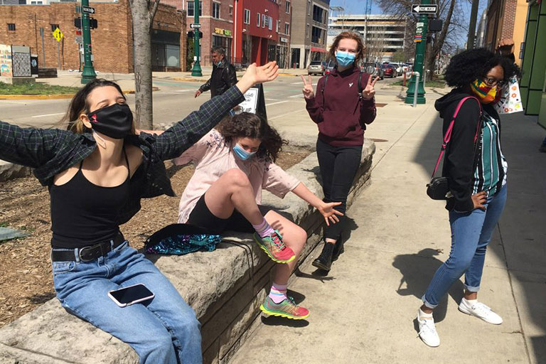 A group of four young women, masked up, and on the streets of Bloomington.